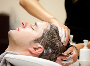 Male client having hair washed