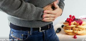 Male holding his stomach.
