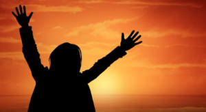 Silhouette of person waving.