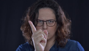 Man wearing glasses wagging finger