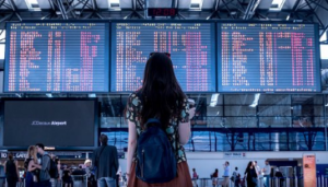 Woman looking at flight schedule at the airport.