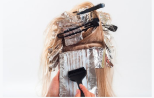 Person having hair bleached with foils