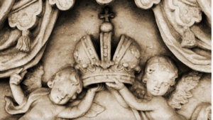 Sculpture of two cherubs holding a crown between them.