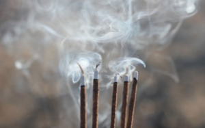 Five burning incense sticks.