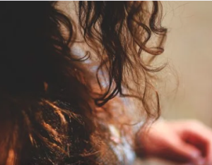 Ends of curly, dark brown hair.