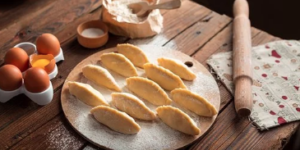 Baked good on a plate with utensils and ingredients around it.