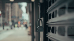 A closed business with a padlock hanging outside.