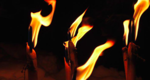 Three stick torches burning.