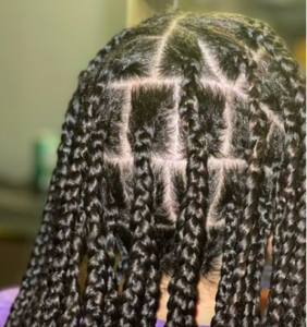 A head of black box braid hair extensions.