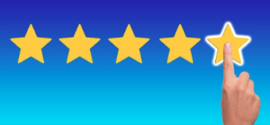A hand touching the last star of a 5-star review.