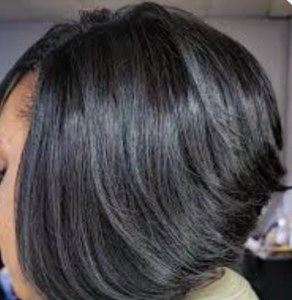African-American female with a black, straightened weave cut in an inverted-bob style.