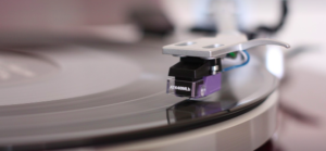 Image of a silver and purple accent vinyl record player.