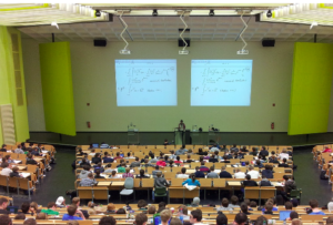 Back view of a lecture hall full of students at a university.