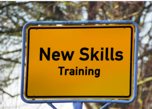 A yellow sign with a light blue trim with black writing saying "new skills training"