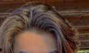 Dark blond hair with a middle part.