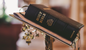 A black bible on a rostrum.