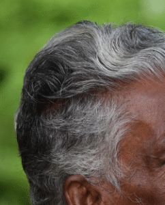 Dark gray hair with white highlights.