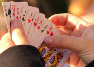 A pair of hands spreading playing cards.