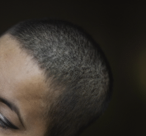 A female with black, short cropped hair.