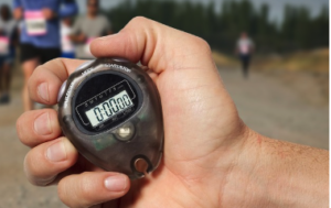 A person's hand holding a timer.