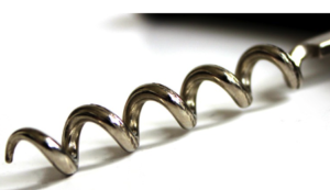 A metal spiral auger against a white background