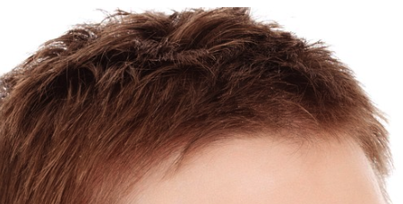 A short, auburn pixie cut.