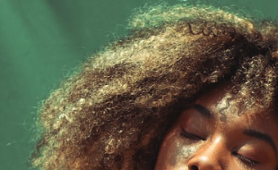 Highlighted blond super curly 4C hair.